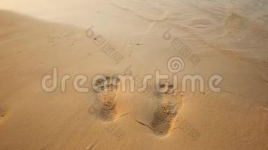 光秃秃的沙滩上的人类脚印被海浪冲走了